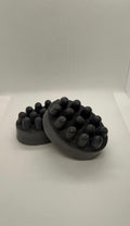 Dark activated charcoal and goat milk soap bars with raised rounded bumps
